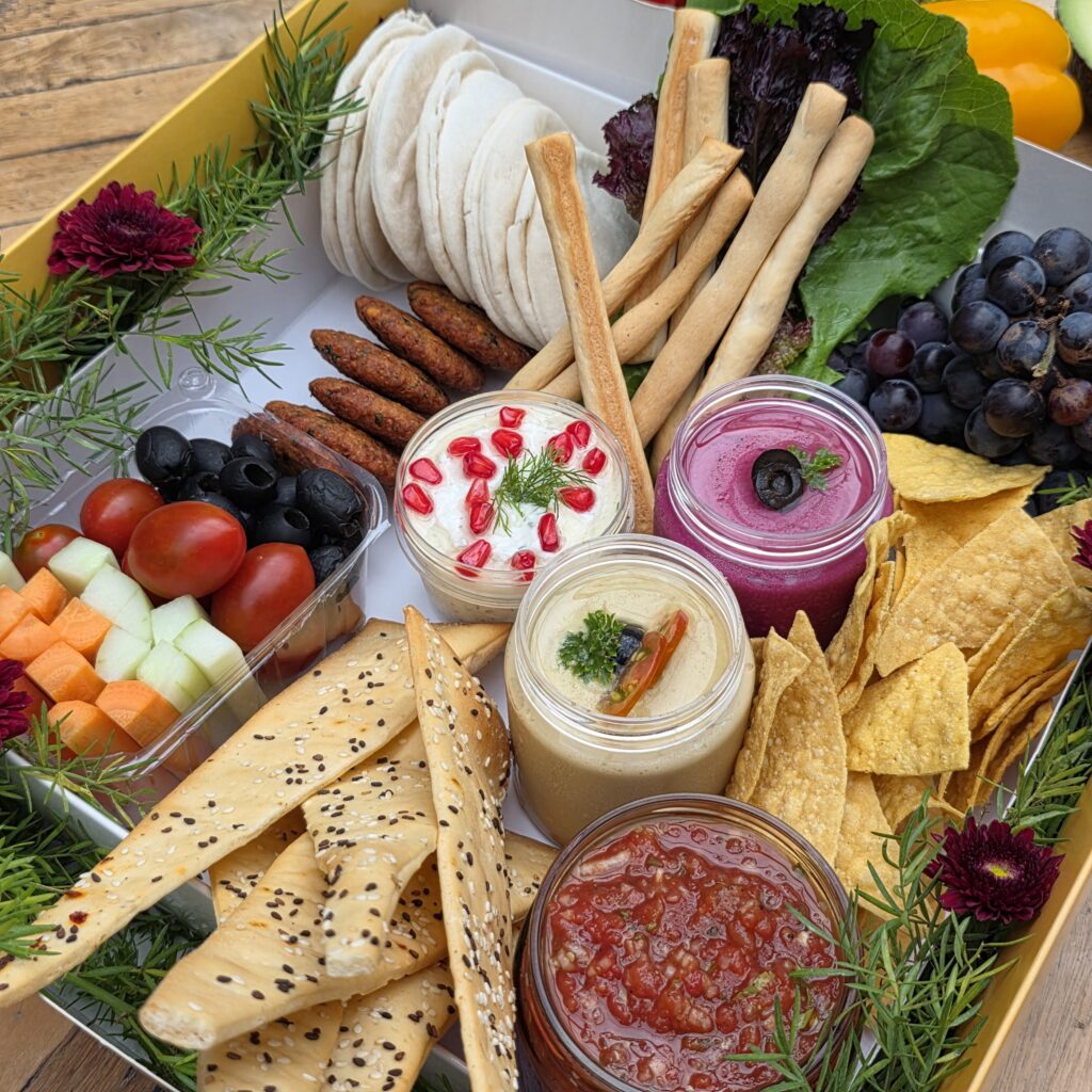 Luxury Charcuterie Board – Assorted cheeses, crackers, lavash, berries, grapes, nuts, and creamy dips.