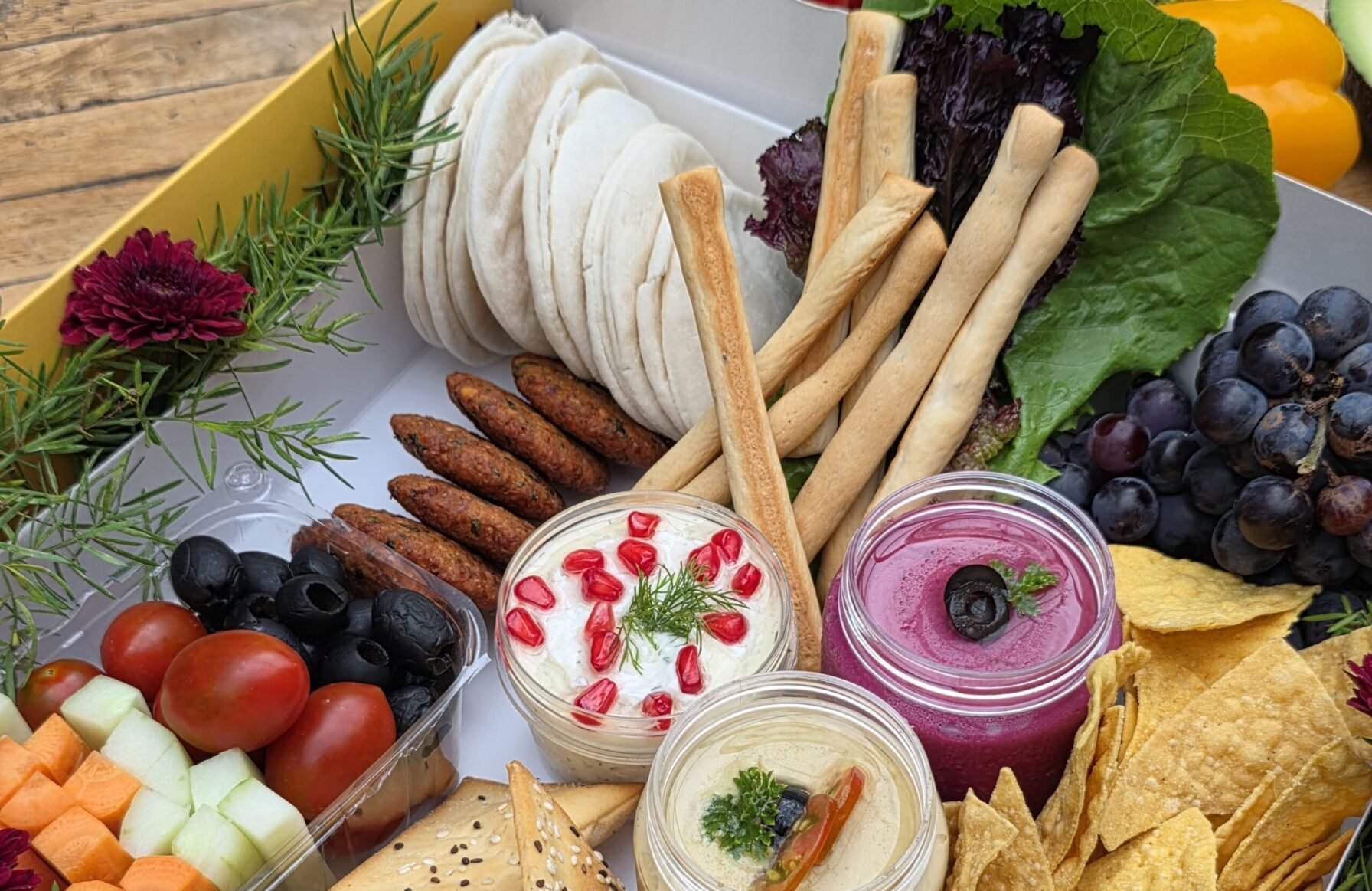 Luxury Charcuterie Board – Assorted cheeses, crackers, lavash, berries, grapes, nuts, and creamy dips.