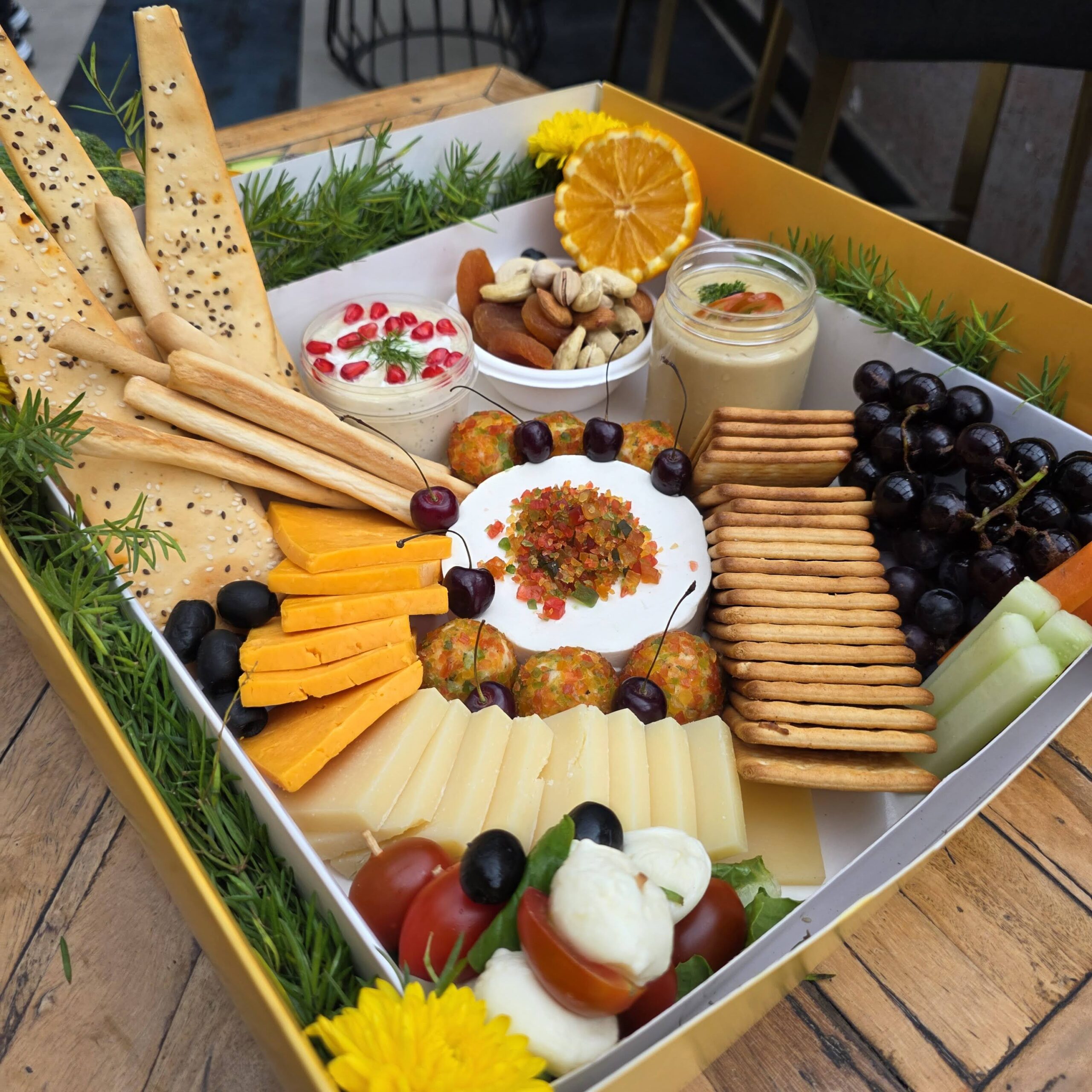 Mediterranean Mezze Platter Box – Grazing box with hummus, beetroot hummus, tzatziki, pita, lavash, olives, grapes, and nachos.