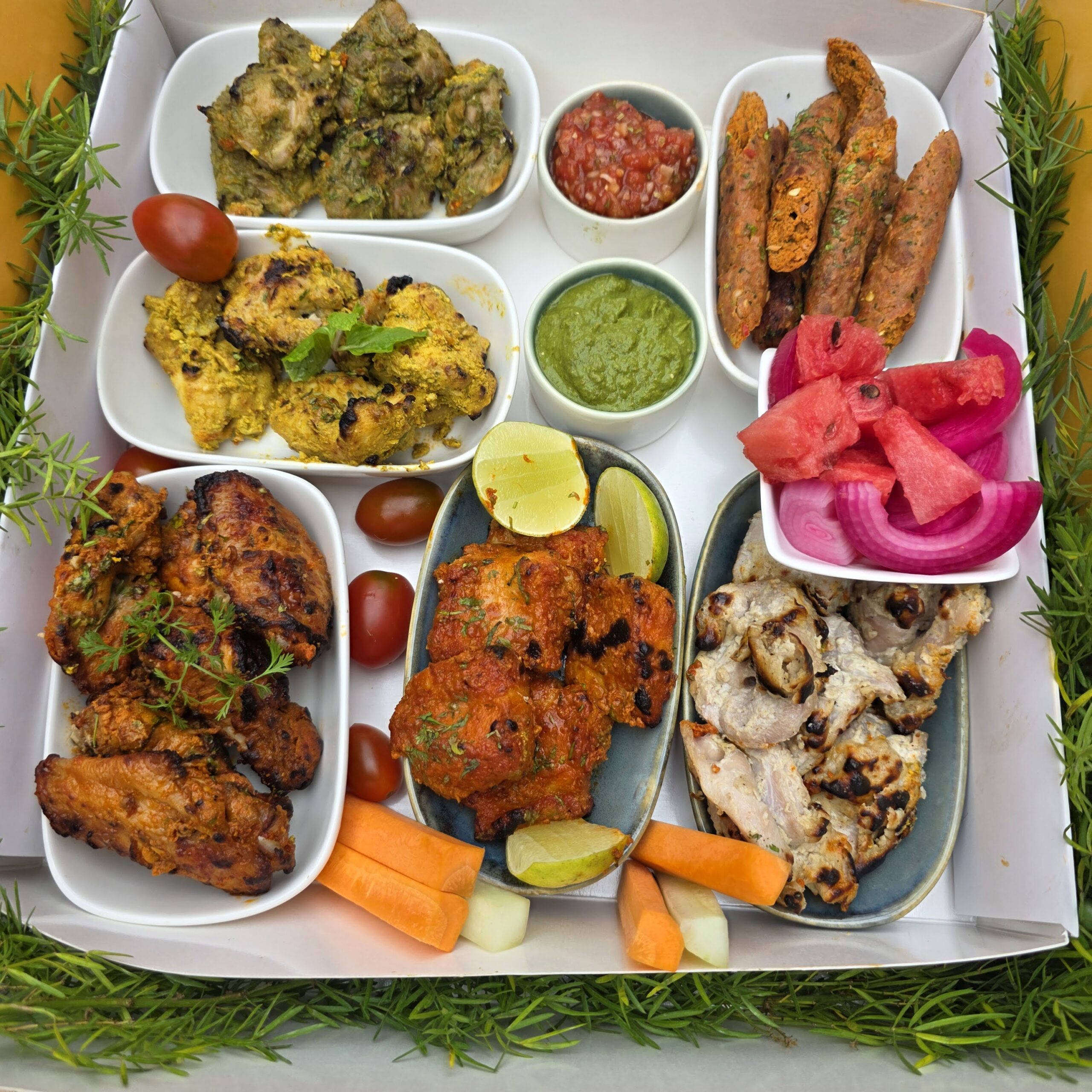 Tandoori Nights Non-Veg Platter – Non-veg kebabs with tandoori chicken, malai chicken, mutton seekh, wings, chutneys, and fresh fruit.